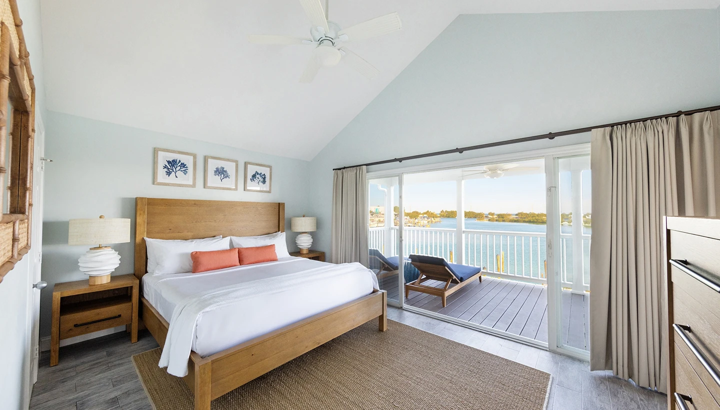 Spacious 4-bedroom premium villa at Hawks Cay featuring a king bed and a private balcony with scenic water views.