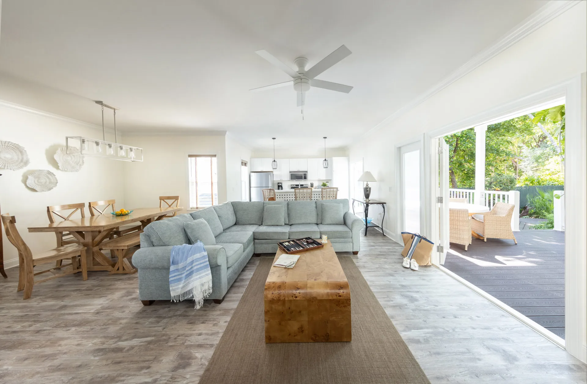 Modern 3-bedroom premium villa at Hawks Cay with a grey sectional and dining area opening to a private pool deck.