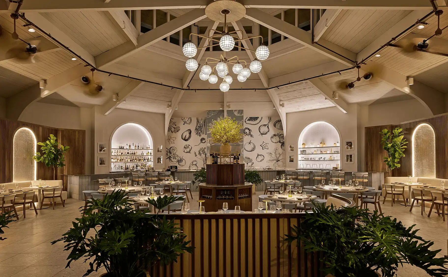 Salt and Ash dining room with high vaulted ceilings, orb chandelier, and artistic wall murals.