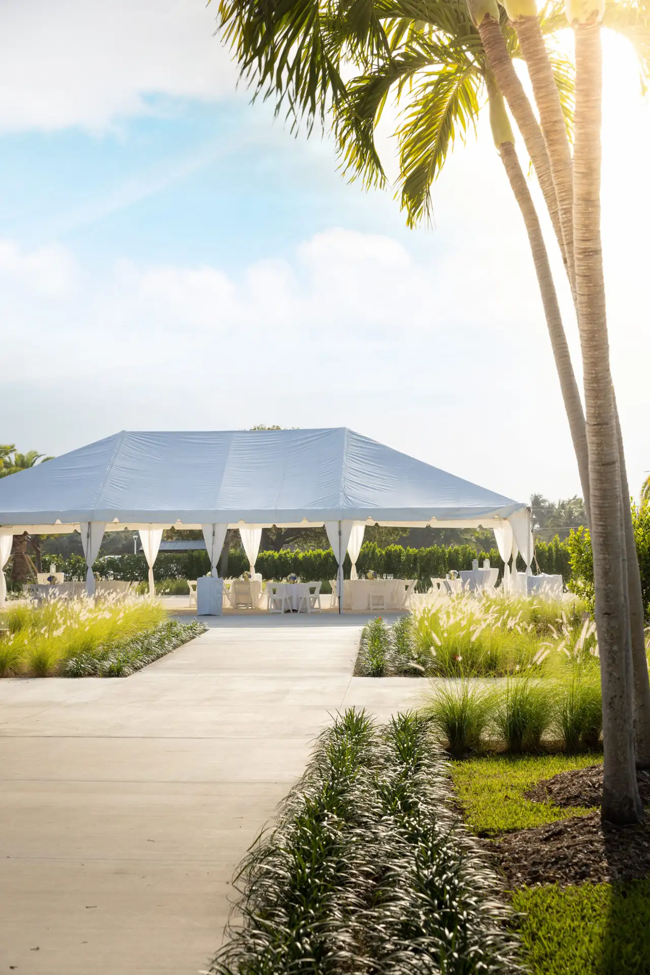 Large white event tent with elegant draped fabric set up for a Hawks Cay outdoor wedding or celebration.