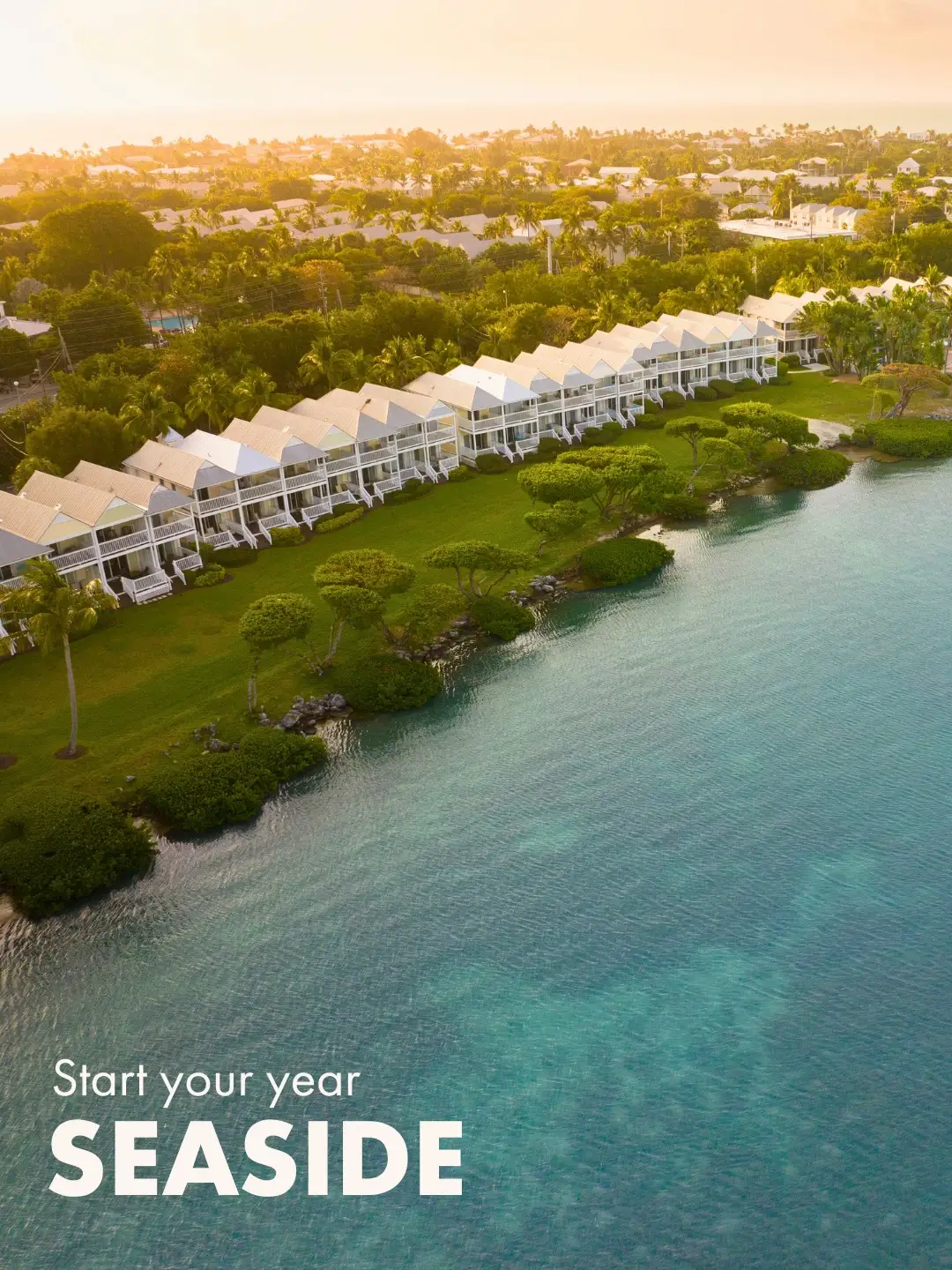 Aerial view of white waterfront villas at Hawks Cay with the text "Start your year SEASIDE."